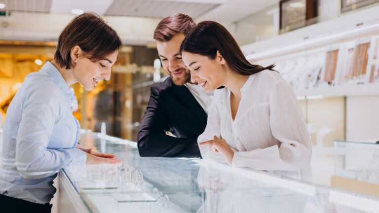 Couple at jewelry shop choosing a necklace together